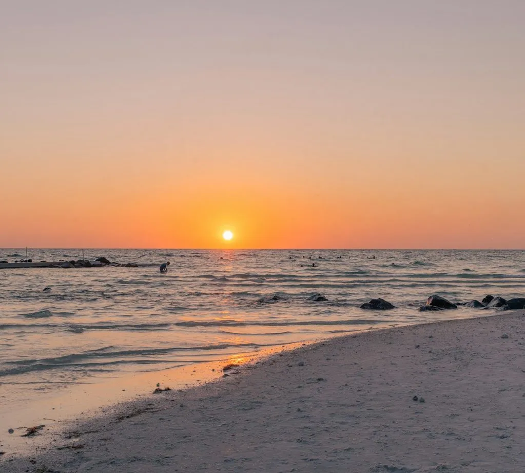 The sun setting over the Gulf of Mexico from the beach at Honeymoon Island.